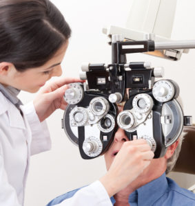 optometrist performing eye exam