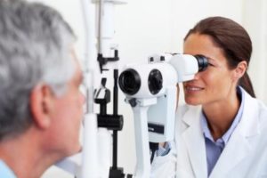 optometrist performing eye exam