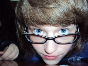 boy looking over glasses