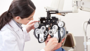 optometrist performing eye exam